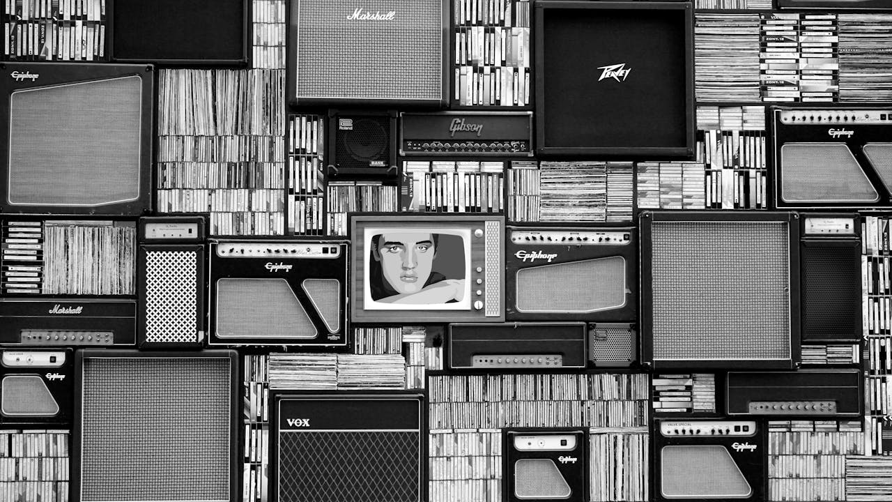 Vintage amplifiers and vinyl records arranged in a striking black and white pattern.